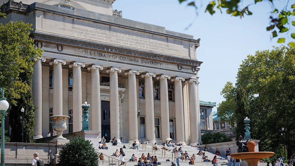 image of columbia university library, with students sitting and walking on the steps
