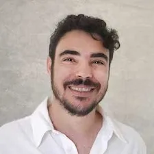 image of Prof. Ameer Marzok standing in front of a blank wall