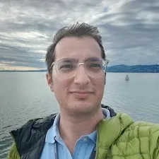 image of Dr. Elad Arad standing in front of open water