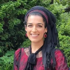 image of dr. Natalie Fardian-Melamed standing in front of greenery.